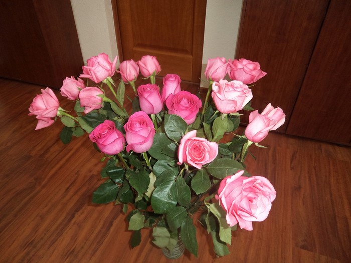 Bouquet of pink roses on a wooden floor