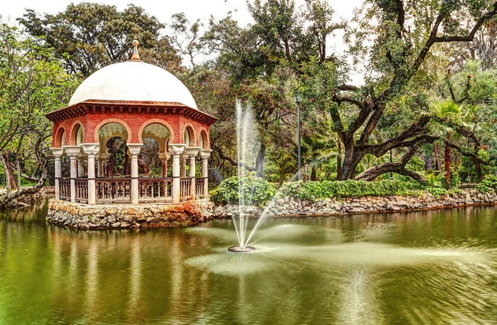 Gazebo by a pond with a fountain in Maria Luisa Park, Seville, Spain