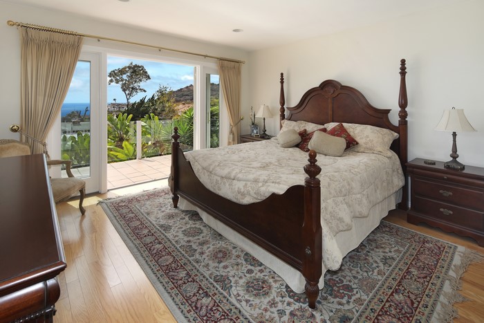 Bedroom with a four-poster bed and ocean view
