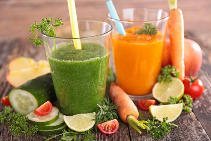 Green and Orange Smoothies with Fresh Ingredients