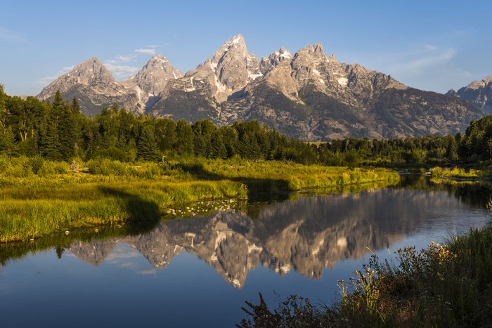 Grand Teton Mountains reflected in a river