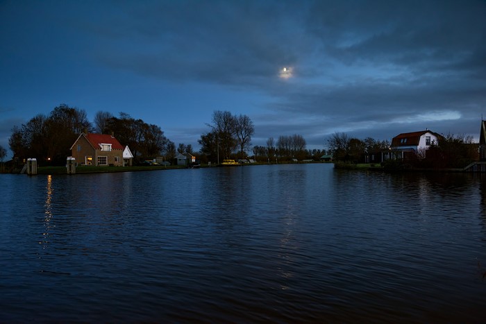 Houses and river at dusk in Spijkerboor, Netherlands