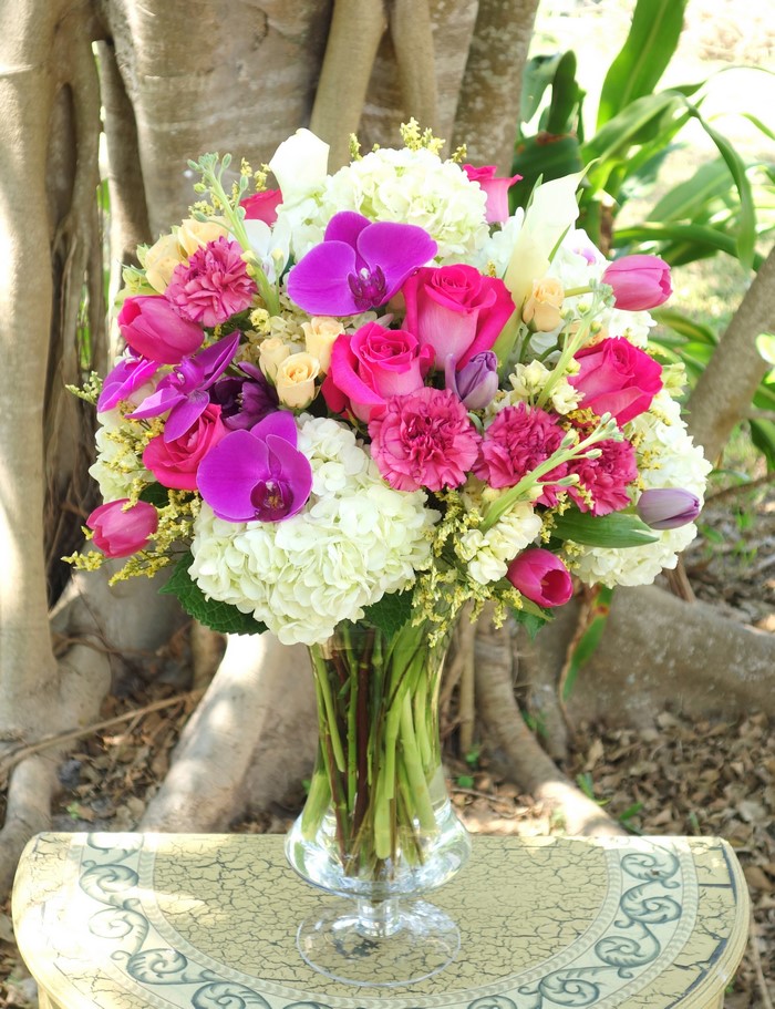 Pink and purple floral arrangement in a glass vase