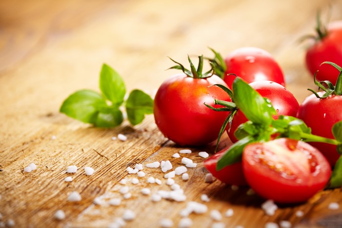 Tomatoes with Basil and Salt on Wood