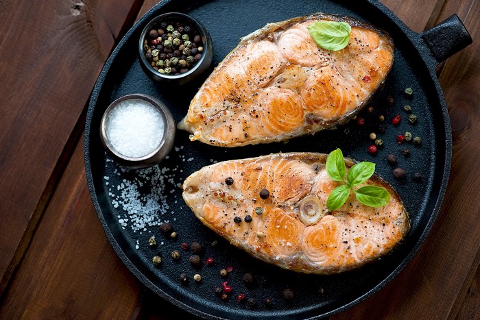 Two salmon steaks with salt and pepper