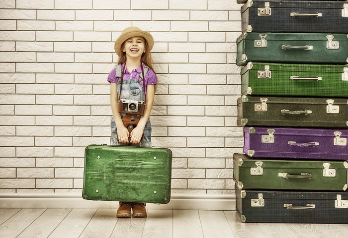Little girl with suitcase and camera