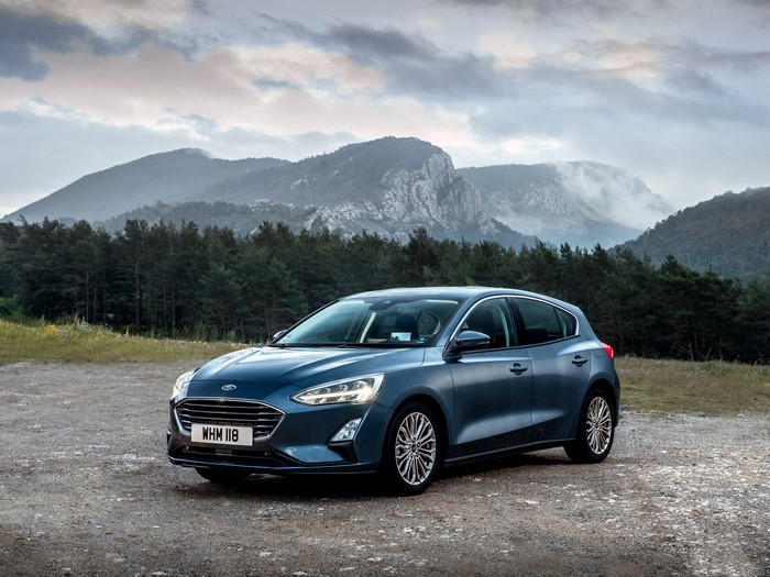 Blue Ford Focus Titanium parked in a mountainous landscape
