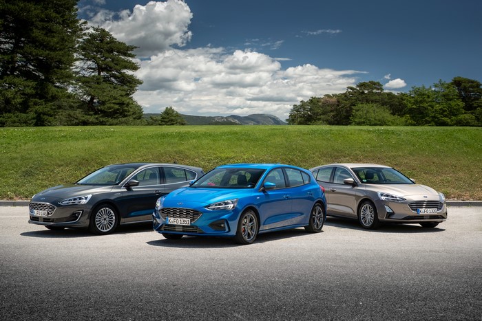 Three Ford Focus cars parked outdoors