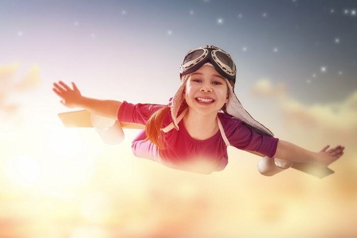 Girl with airplane wings flying