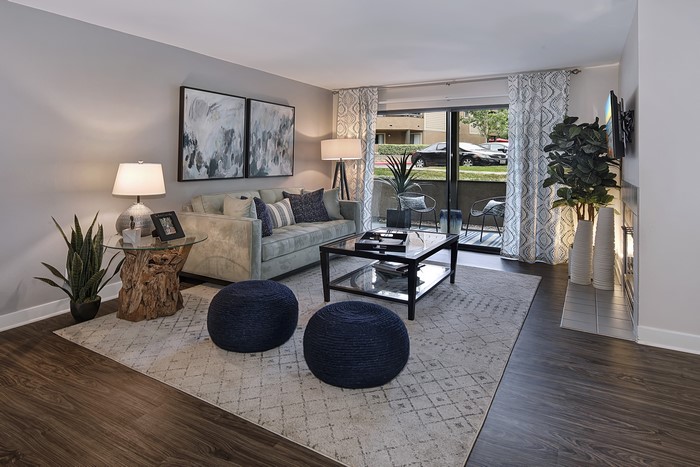 Living room with sofa, lamps, and carpet