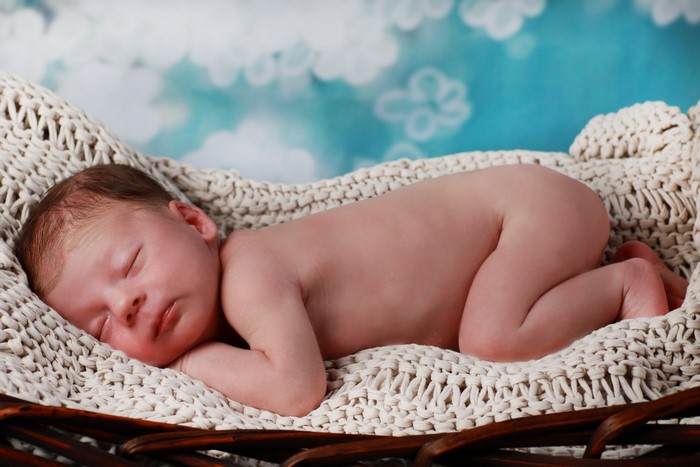 Newborn baby sleeping in a basket