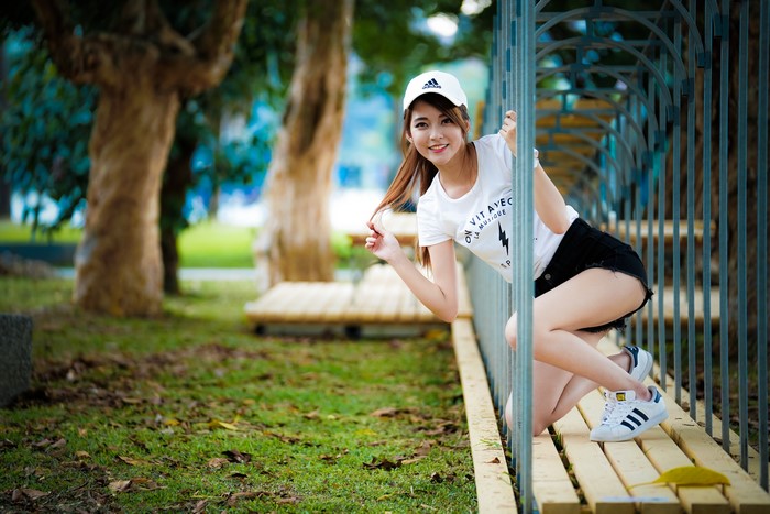 Asian girl in Adidas cap and t-shirt