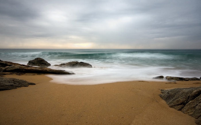 Long exposure of waves crashing on a rocky beach