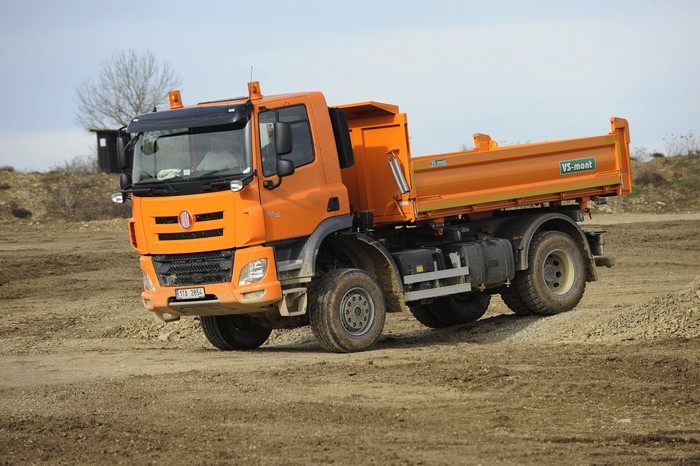 Orange dump truck on a construction site