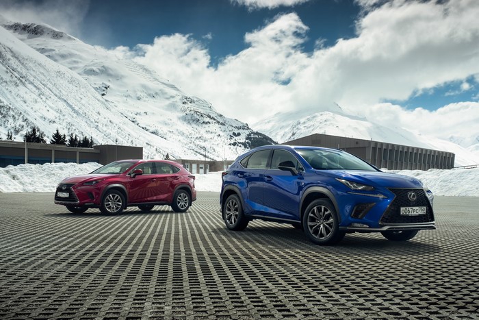 Two Lexus NX cars in snowy mountains