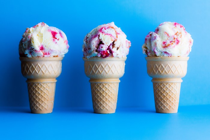 Three ice cream cones on a blue background
