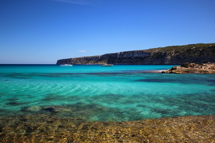 Turquoise sea with boats near Formentera coast, Spain