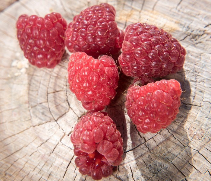 Close-up of fresh raspberries on a wooden surface
