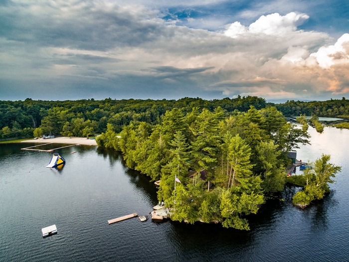 Aerial view of Mastens Lake with a water slide and island