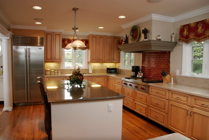 Kitchen with island, refrigerator, and cabinets