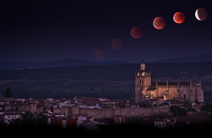 Lunar eclipse over Coria, Spain with cathedral