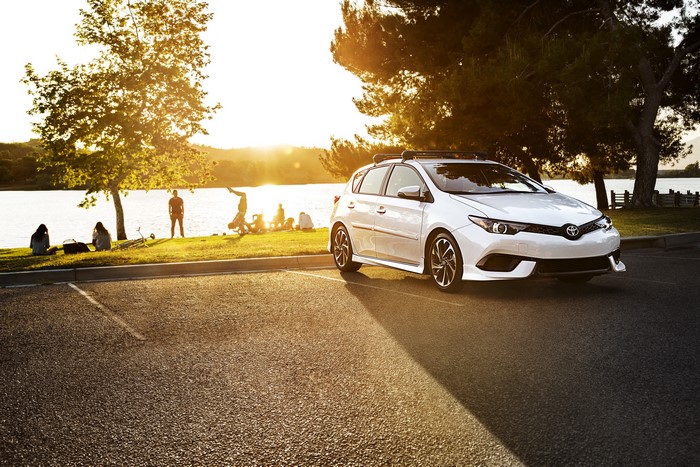 White 2017 Toyota Corolla iM parked by a lake at sunset