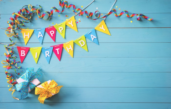 Birthday banner and gifts on wood planks
