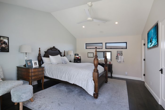 Bedroom with four-poster bed and TV