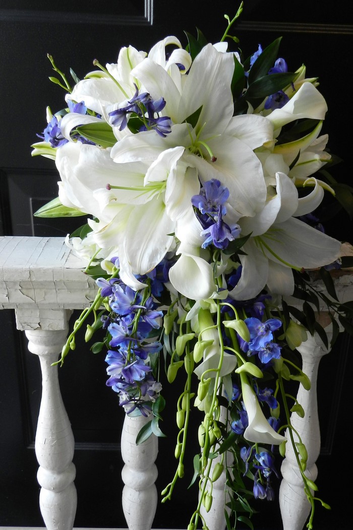 White lilies and blue delphiniums bouquet