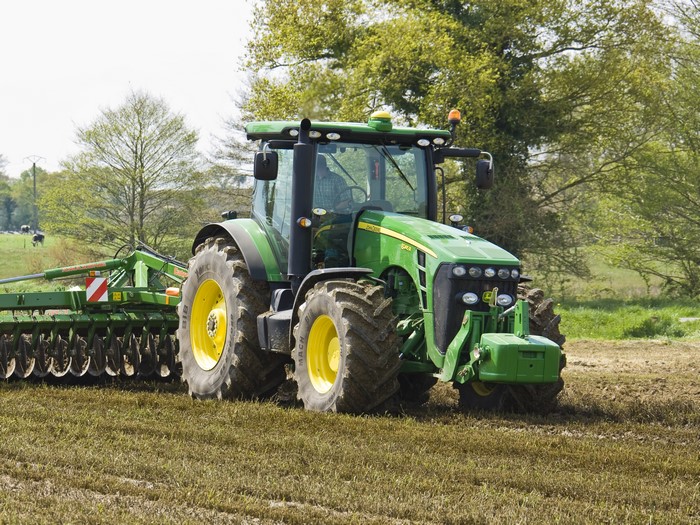 2009-13 John Deere 8245R tractor plowing a field