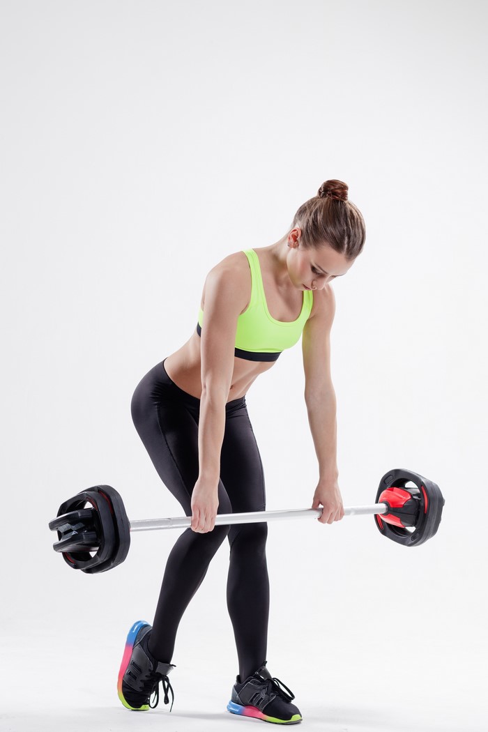 Woman performing barbell row workout