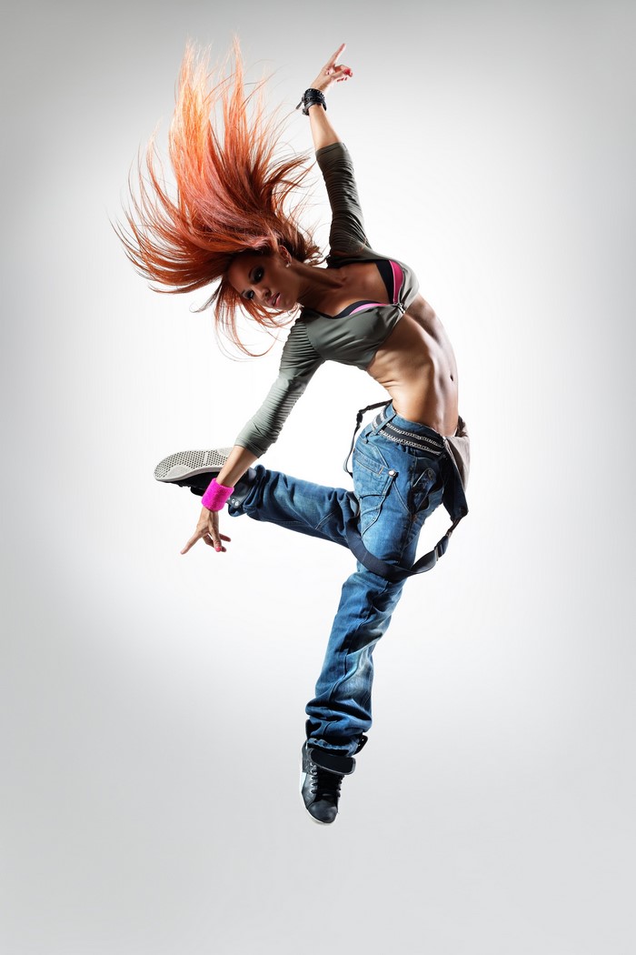 Woman in jeans jumping with red hair