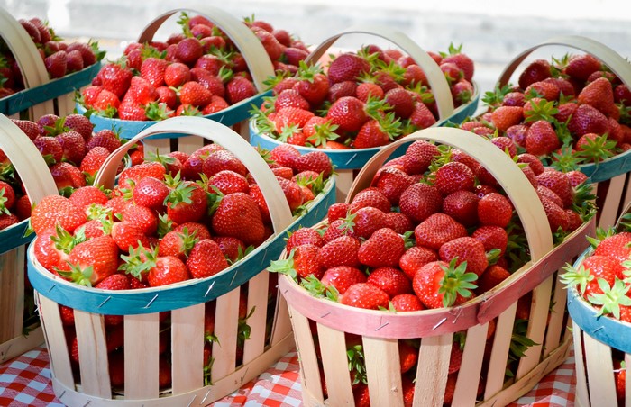 Baskets of fresh strawberries at a market