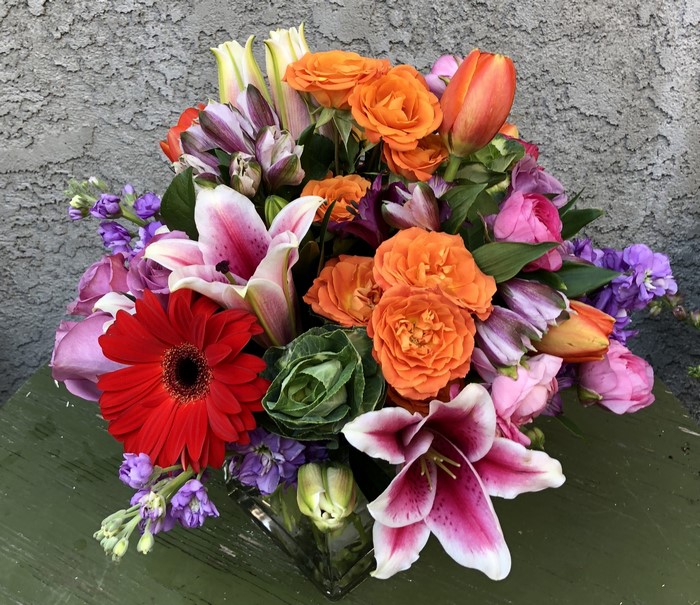 Colorful floral arrangement with lilies, roses, and gerberas