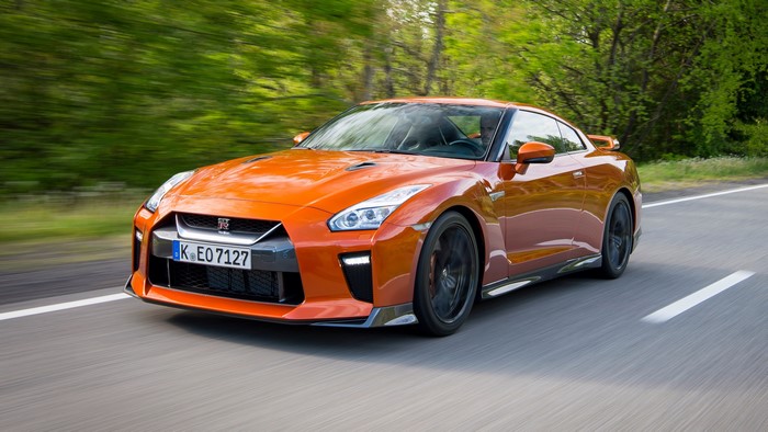 Orange Nissan GT-R driving on a road