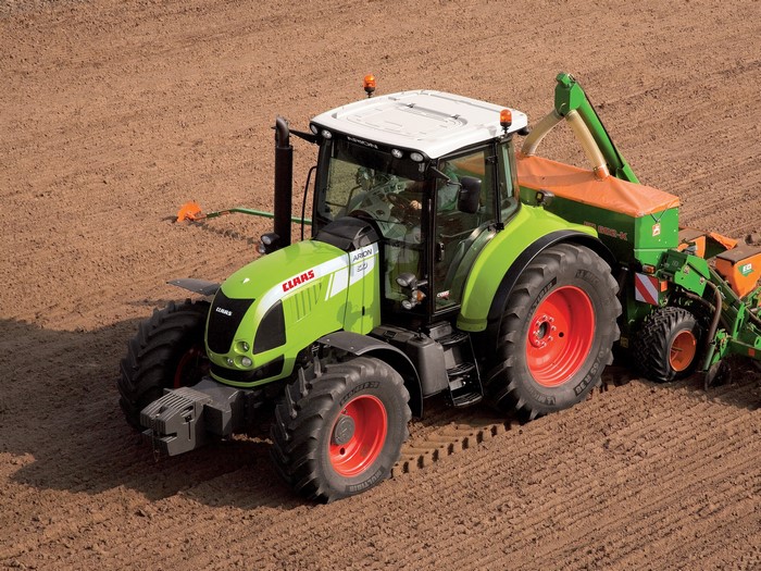 Claas Arion 610 tractor with seeder in field
