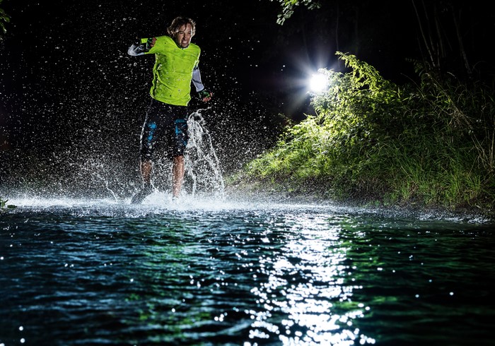 Man running through water at night