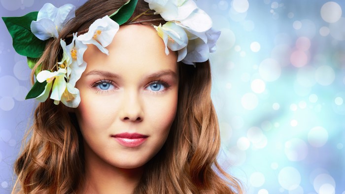 Woman with flower crown and blue eyes