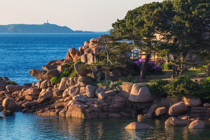 Coastline with granite rocks and a house in Brittany, France