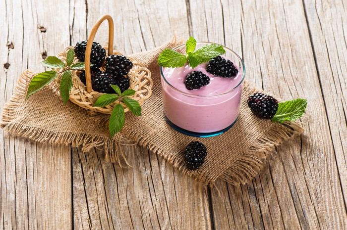 Yogurt with Blackberries and Mint on Wood