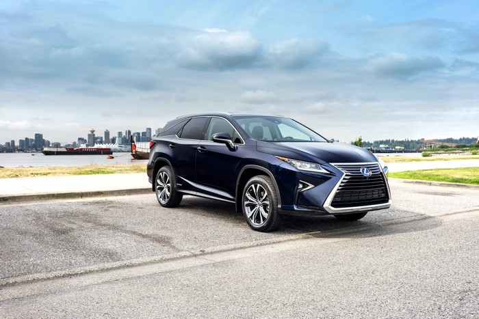 Blue 2018 Lexus RX 450hL parked by water