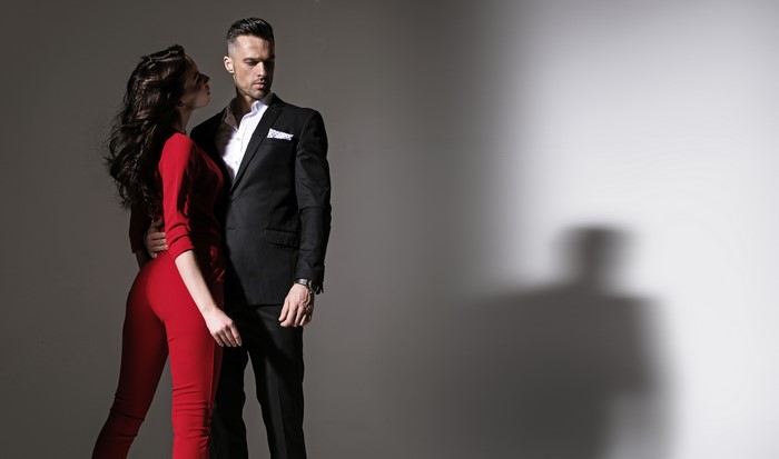 Man in Suit and Woman in Red Jumpsuit