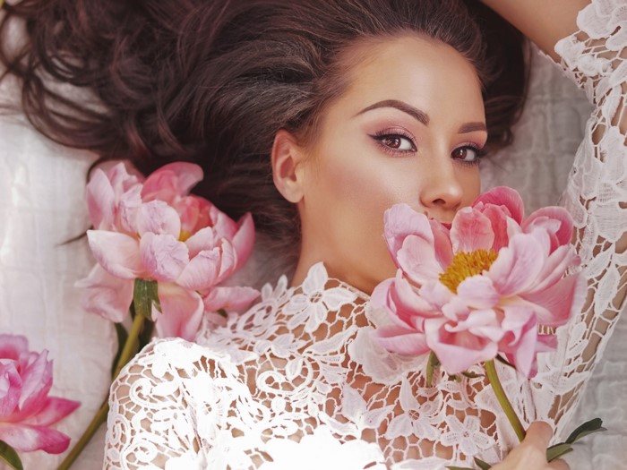 Woman with pink peonies and lace dress