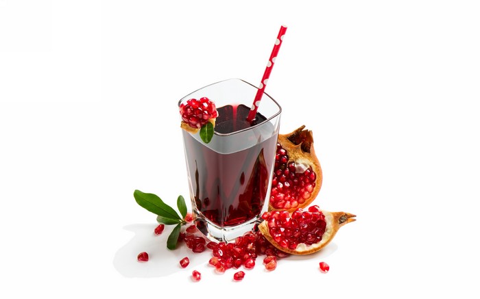 Pomegranate Juice in Highball Glass with Pomegranates