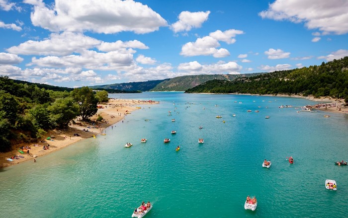 People enjoying a sunny day at a lake in France