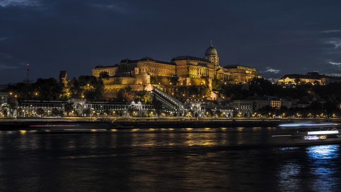 Buda Castle illuminated at night over the Danube River in Budapest, Hungary
