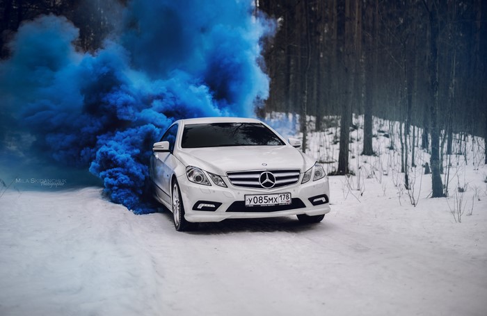 White Mercedes-Benz E-Class Coupe with blue smoke