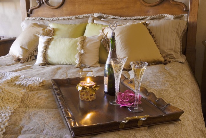 Champagne and Candle on a Bed