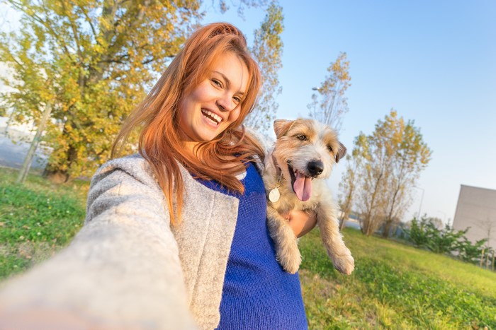 Girl taking a selfie with her dog
