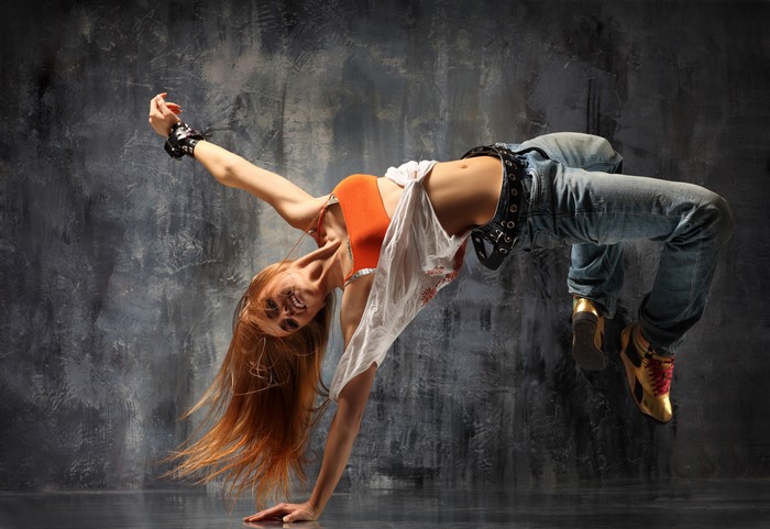Redhead girl dancing in jeans